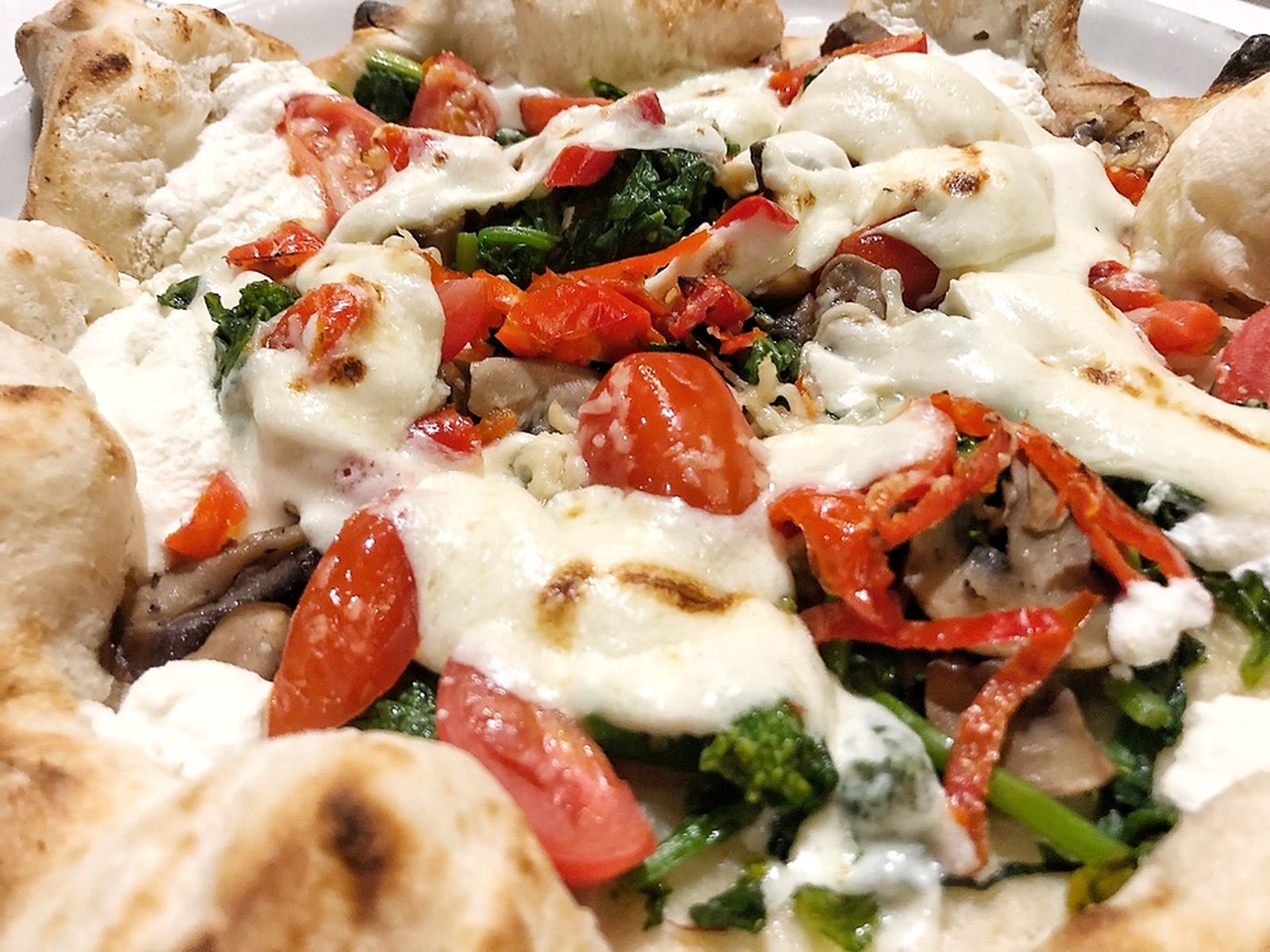 Vegetarians can enjoy this stuffed crust verdura pizza with broccoli rabe, mushrooms, tomato, peppadew peppers, and fresh herbs.