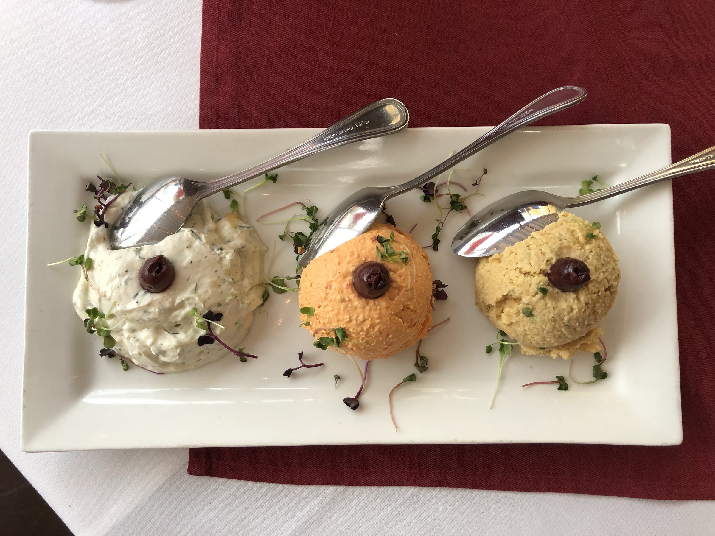 Dip trio: Tzaziki, ktipiti (roasted red pepper with feta), and hummus (ground chickpea with herbs and spices)