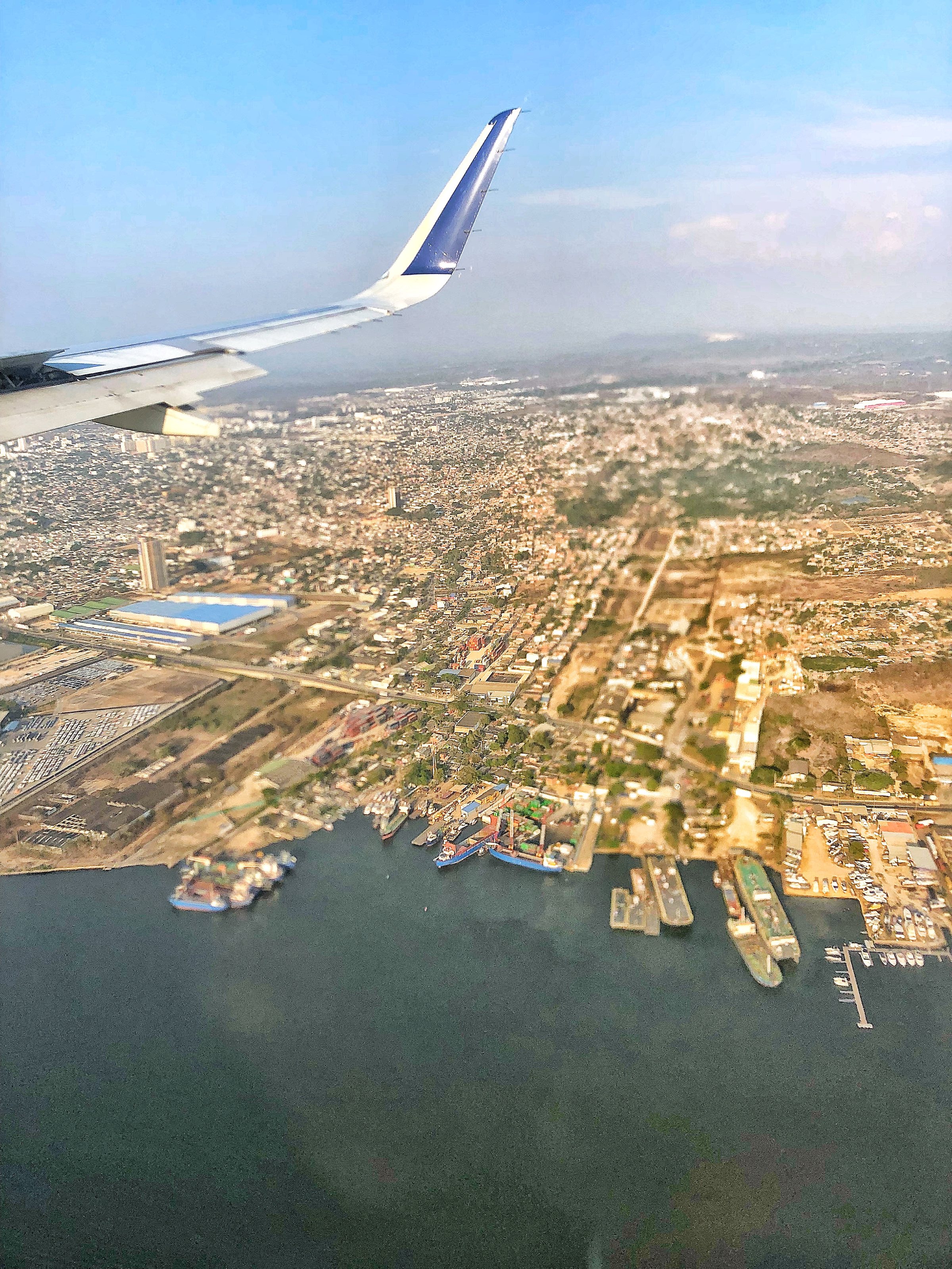 handling the health strains of travel - plane over Cartagena coastline