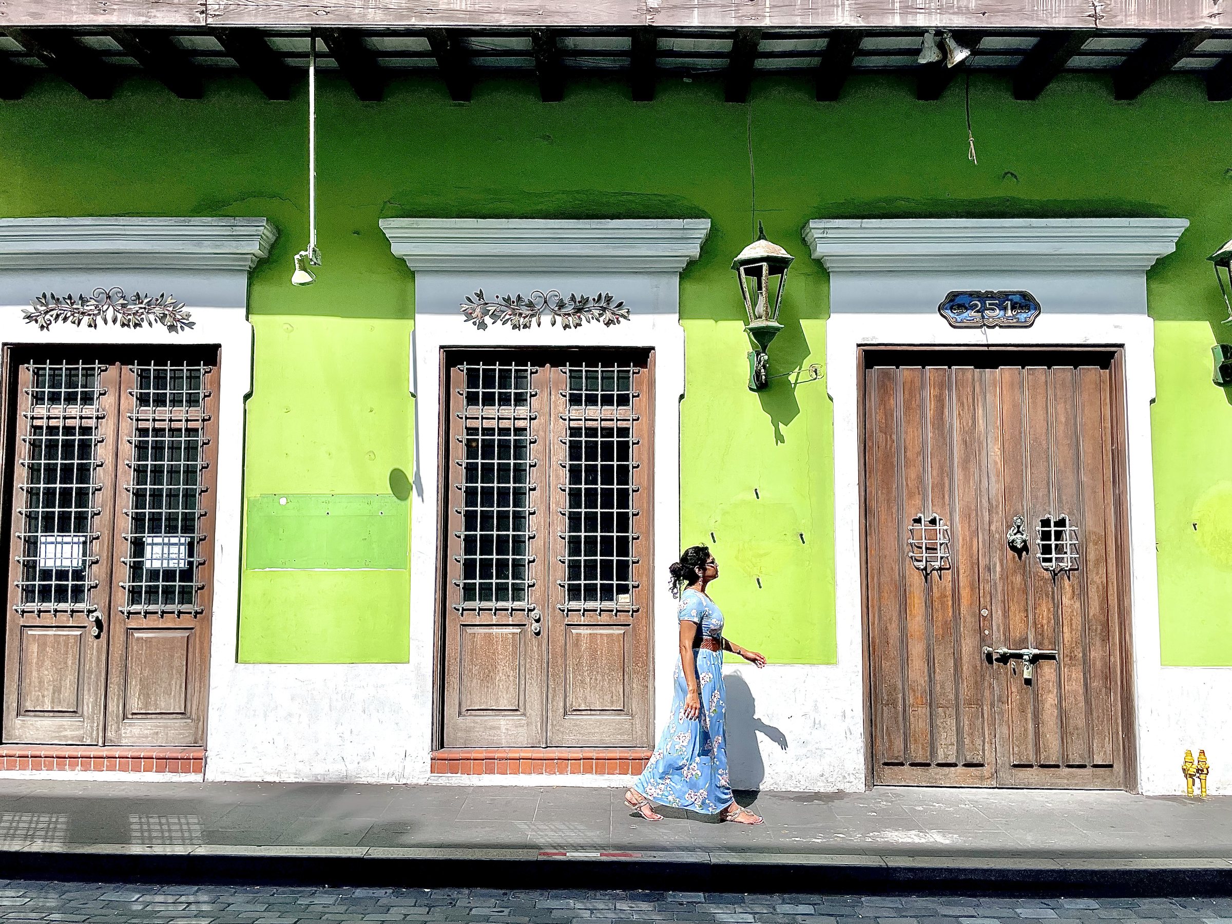 woman walking through colorful streets of old San Juan