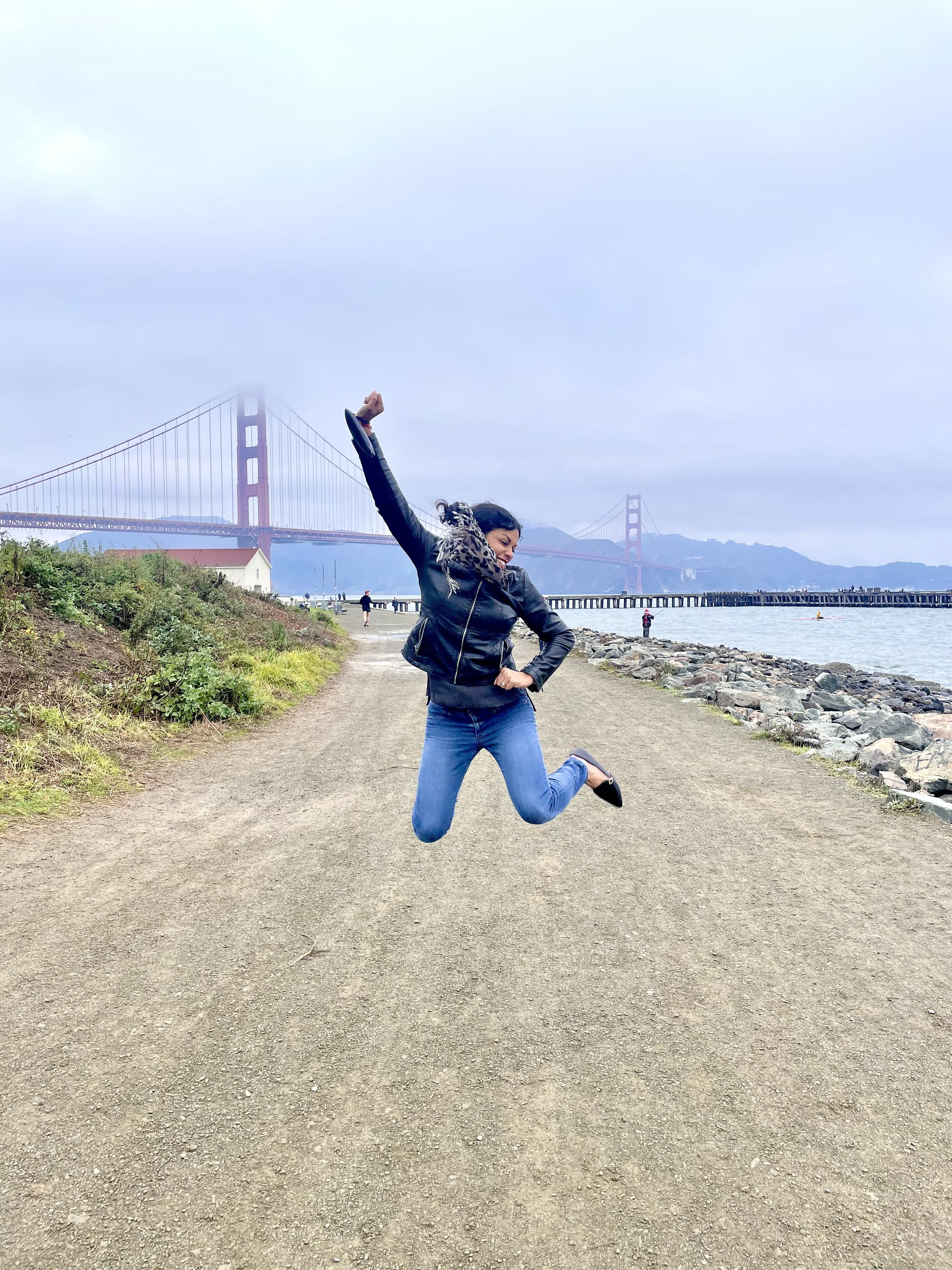 jumping in front of Golden Gate Bridge